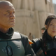 The helmetless Boba stands in the middle of a Tatooine city street while Fennic Shand looks at him reproachfully.